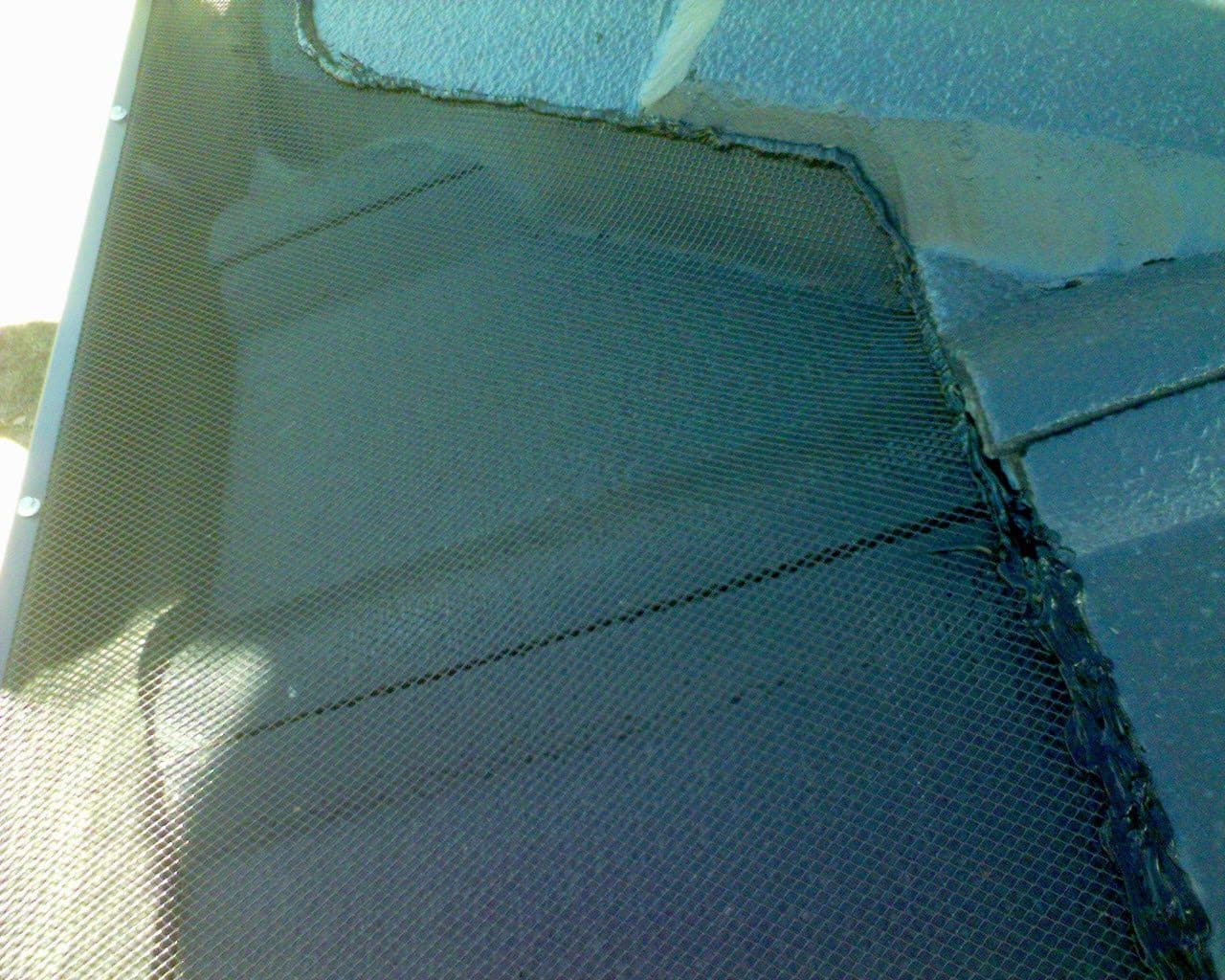 Close-up of gutter guard mesh finishing the valley of a tiled roof
